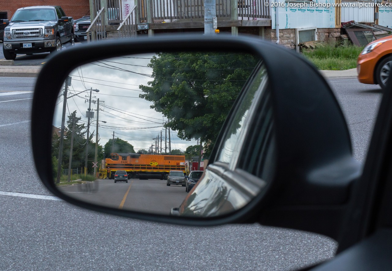 Objects in Mirror Are Closer Than They Appear.  RLHH 3049 leads train 598 across Grey Street on their way to Ingenia in downtown Brantford.