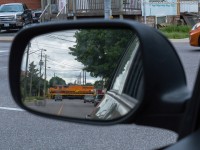 Objects in Mirror Are Closer Than They Appear.  RLHH 3049 leads train 496 across Grey Street on their way to Ingenia in downtown Brantford.