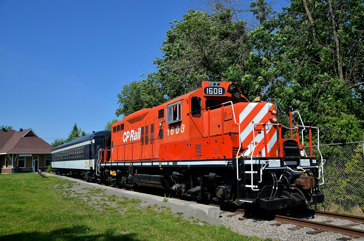 Changes in Exporail's excursion train. Exporail's Sunday-only excursion train is seen in front of the Des Bouleaux station, where the train stops for 10 minutes before its short run back to Barrington Station at Exporail. There are two noticeable changes this year. The passenger car is now CN 5064 in place of AMT 827 and the power (GP9 CP 1608 in this case) now faces south instead of north, allowing for much better pictures in the afternoon.