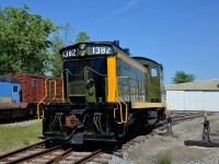 <b>A preserved end cab switcher.</b> CN 1382 (formerly CN 7300, and donated to Exporail during the summer of 2014) is parked in front of one the hangars on a very hot and humid day.