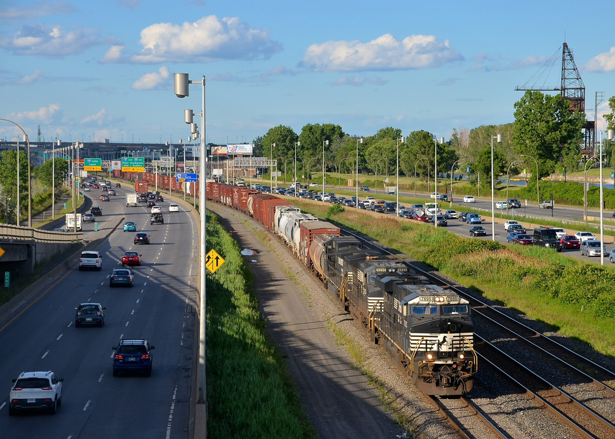 CN 529, with a coke crane in the background. CN 529 is seen approaching Turcot West in Montreal  this evening during some nice evening light. Power is ES40DC NS 7695 and Dash9's NS 9233 & NS 9365 with a short train of perhaps 25-30 cars in tow. In the right of the frame is a crane that was used to unload coal from ships along the Lachine canal for Lasalle Coke, an operation that was discontinued in the mid-1970's.