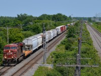 <b>CP 119 wins another race.</b> Three weeks back <a href=http://www.railpictures.ca/?attachment_id=24935/>I shot</a> CP 119 on the CP Vaudreuil sub with a lead over CN 327 on the parallel CN Kingston sub in Pointe-Claire. Here, a bit further west in Sainte-Anne-de-Bellevue, CP 119 is winning another race, with CN 327 off in the distance. CP 119 is doing track speed whereas CN 327 is just starting to accelerate after having to hold for three eastbounds and one westbound ahead of it due to a work block. CP 119 has CP 8816 at the head end and CP 8636 mid-train. 