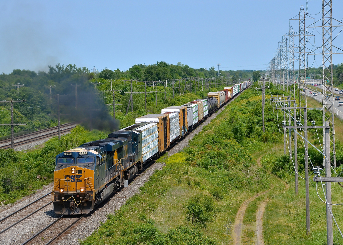 Dash8 smoke. The trailing Dash8-40CW on CN 327 (CSXT 7719) erupts in smoke as the train starts to accelerate after having to wait for two eastbounds to pass and CN 377 to leave ahead of it on a portion of the Kingston sub that is temporarily single track due to trackwork. Leading is CSXT 896.