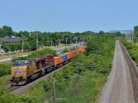 <b>A UP leader on CP.</b> UP 5534 and CP 8870 lead CP 143 west through Pointe-Claire on the south track of the CP Vaudreuil Sub. At right is the CN Kingston sub; both main lines parallel each other for many miles in Montreal and just west of it.
