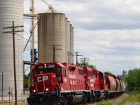 Another day's CP local T14 gets underway beyond the cover of wild flowers after switching out ADM down the spur to the right. While GP38s and GP20s may not be the most interesting power out on the road these days, a look beyond the red paint can sometimes reveal a little interesting history. The high headlight and 4500 number series on the lead unit reveals the unit was once SOO Line 4508. Dig a bit deeper and the history reveals it started life as Milwaukee Road #358. A rebuild a few years ago gave it its CP red coat and is also now equipped for remote control operation.