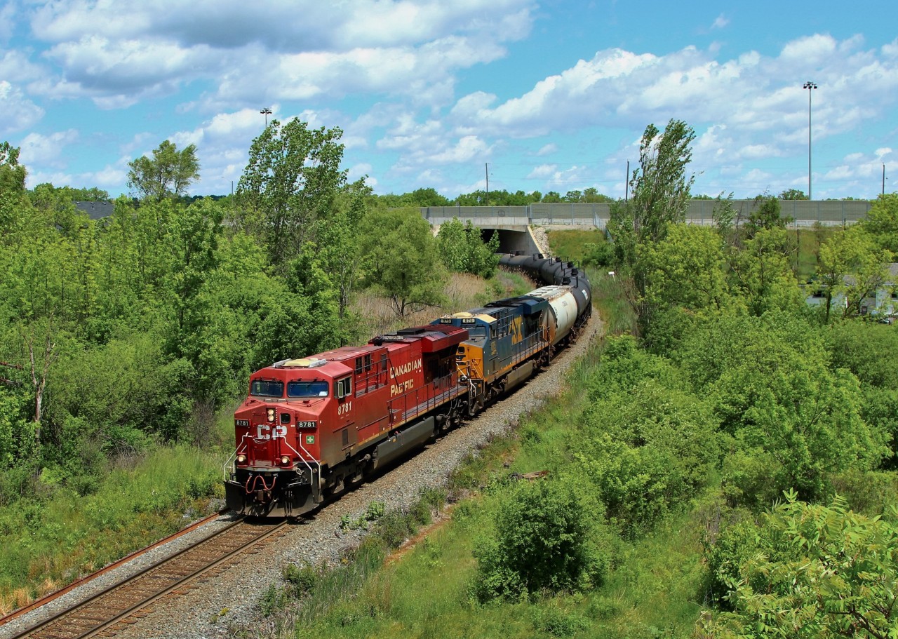 With the sun playing games with me today, I had to make a small trek to get a good sun angle and hope the clouds in the sky didn't play games with me again. Here, CP 646 with CP 8781 and CSX 875 for assistance, work the 6100 foot ethanol train down the escarpment under Highway 6 on approach to the Newman Rd. overpass on the way to Desjardins.