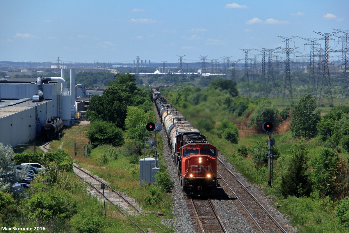 An extra M382 rolls under Weston Road with a duo of SD75I motors providing power, as they hustle to keep the train moving past CN Humber.