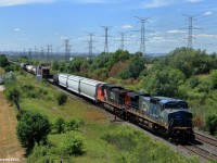 In 2016, Illinois Central "Blue Devil" 2457 is on point of manifest train M394 as they roll by Weston Road on the Halton Subdivision in the last few miles of their journey, arriving into MacMillan Yard with the leader still wearing its blue paint.