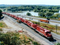 Us lads trackside certainly did a lot of whining over ugly, grubby CP locomotives on the lead of many trains this past couple of years, their very presence often ruining the overall classy photo we hoped to capture. Now, suddenly, I notice they have vanished.  Apparently most all the 9500 series (AC4400CW)units have gone into storage due to a downturn of traffic. So the opportunity to dig up a photo of back when these were new out of Erie PA, a scant 21 years ago, presents itself.  Here is train #521 (USA to Toronto) as seen from beside the High Level bridge in Hamilton. For viewers out of province, that is Hwy 403 in background, very quiet looking compared to todays' crush of traffic; and beyond that, Cootes Paradise, a quiet mostly severed (from Hamilton Harbour) protected body of water. Locos that can be seen: CP 6408, 9536, 9531, 9539, 9529, 9528, 9538, 9544, 9545, 9547, 9542 and 9541. The units looked nice when new..but that didn't last. I'm glad CP has since gone back to a better quality of paint.