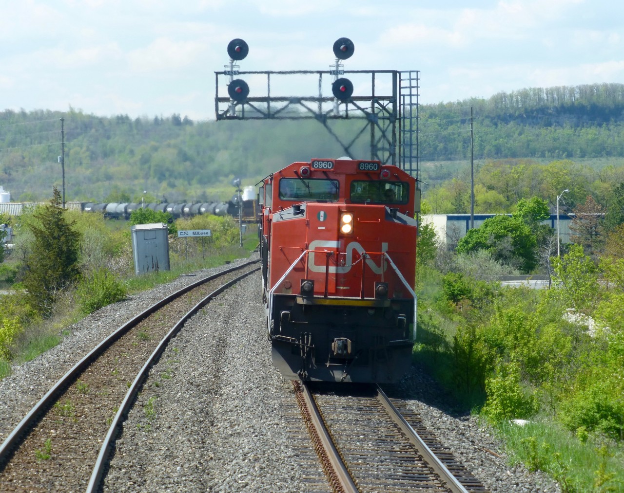 CN 422 lead by SD70M-2 8960 leans into the S curve at Milbase Mi 34.3 on CN's Halton Sub enroute to Mac Yard on a sunny May afternoon.