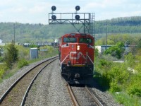 CN 422 lead by SD70M-2 8960 leans into the S curve at Milbase Mi 34.3 on CN's Halton Sub enroute to Mac Yard on a sunny May afternoon.