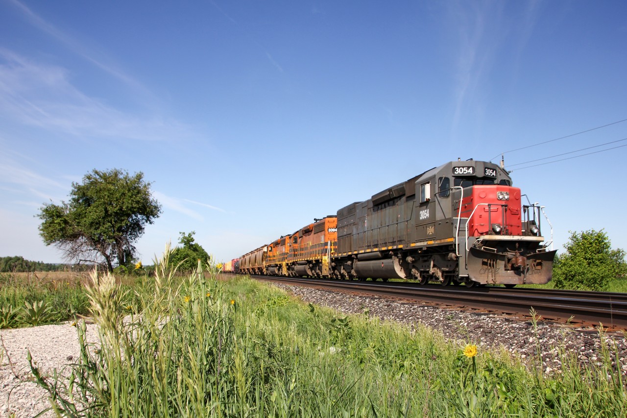 As summer begins to show itself finally, GEXR train 432 is about to cross Heritage Road in Norval, Ontario, bound for CN's Mac Yard. The regular trio of 3054 3393 3394 is back, after a few days/weeks with some yard power on the 431/432 cycle