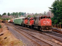 
This power combination up front always intrigued me. I've not seen this particular arrangement before nor since.
Coming up to CN Boyne, which is now the southern(eastern)end of CN-CP shared assets area is a GP9RM in an M-420 sandwich.  CN 3500, 7037 and 3513 were all shed from the roster back in the late 1990s.
