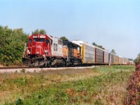 From the USA, closing in on Brookfield, is CP's #523 running on the old line that once crossed thru Clifton Hill, the NF tourist mecca. Train tie-ups aggravated the daylights out of everybody there until the city of Niagara Falls was able to rid themselves of this railroad around 15 years back. On this pleasant fall day we see SOO 769, and HLCX 6366 crossing the country lane of Yocum Rd. The 6366 was a former MILW, now part of the fleet leased by CP which totaled around 200 units at this time. Amazing variety. But how times have changed. Currently CP has over 650 of their own units in storage around the country.