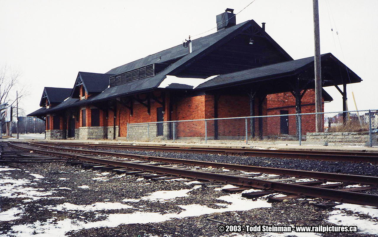 The Toronto, Hamilton & Buffalo Railway built their station in what once was the industrial area for Brantford. The tracks once served the many industries...while passengers would arrive or depart the birthplace of Alexander Graham Bell. 

Today, all industries that were once served by the railway are gone. The Casino sits in it's place. The tracks - although overgrown mainly by weeds now...are still in place. There is only a spur that the SOR services for one lone customer. But for how much longer? 

As for the station, it sat abandoned. Like many others in this position, it was vandalized and suffered fire damage to it's roof. However, it was saved - and became at one point the Iron Horse Restaurant. A new roof and addition to the back of the station doubled it's size. 

However, the station sits vacant again. There have been at least two more restaurants after the Iron Horse, and even a night club at one point occupied the station. All unsuccessful, much like most businesses in this area of Erie Avenue in Brantford.