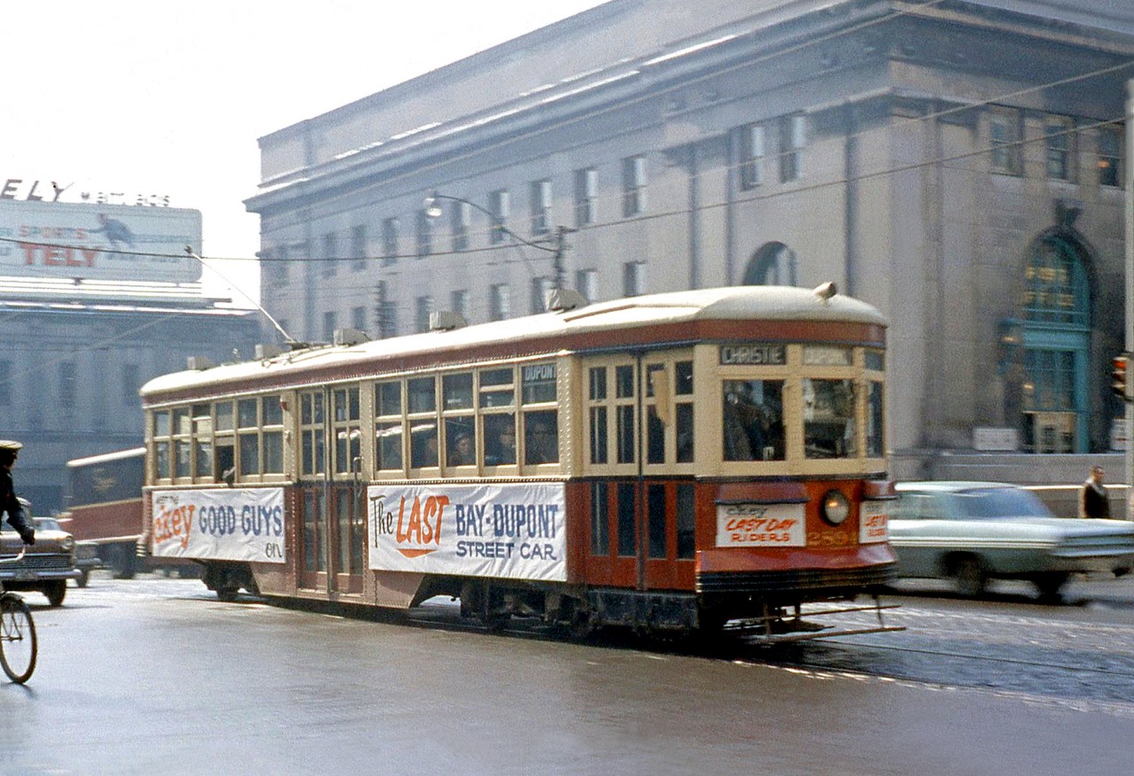 TTC "Small Witt" 2894 is adorned with banners but operating as a regular service car on the last day of Bay-Dupont streetcar service (operated as the Dupont route) on February 28th 1963, seen here headed north on Bay Street at Front Street. The new University subway line that opened the same day ended regular streetcar service on Bay, which was replaced with the route 6 Bay diesel bus and later trolleybus service. In the background Toronto Union Station can be seen, as well as a Simpsons delivery truck about to duck under the rail viaduct.