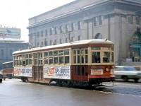TTC "Small Witt" 2894 is adorned with banners but operating as a regular service car on the last day of Bay-Dupont streetcar service (operated as the Dupont route) on February 28th 1963, seen here headed north on Bay Street at Front Street. The new University subway line that opened the same day ended regular streetcar service on Bay, which was replaced with the route 6 Bay diesel bus and later trolleybus service. In the background Toronto Union Station can be seen, as well as a Simpsons delivery truck about to duck under the rail viaduct.
