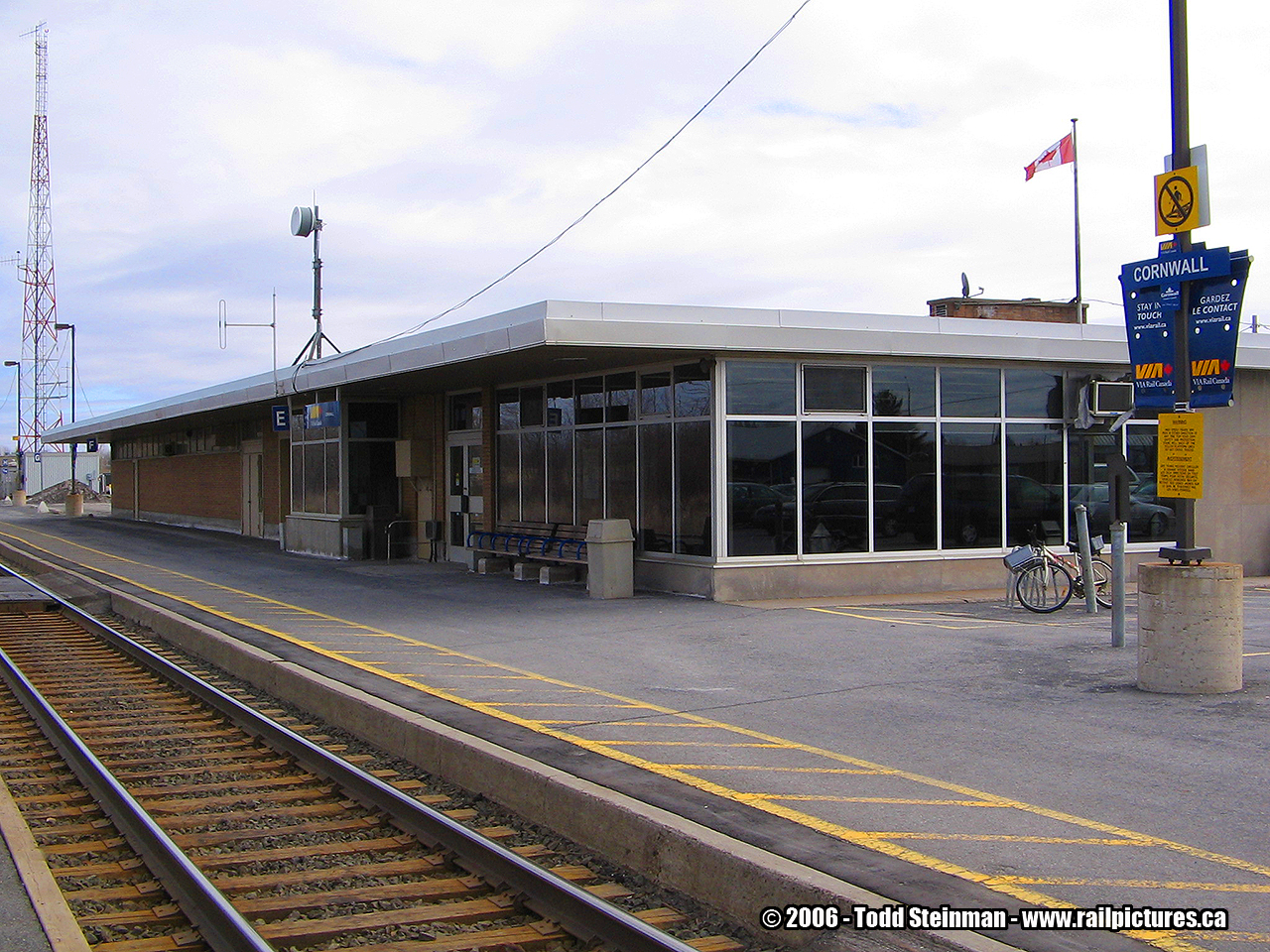 Upon my first visit to Cornwall in 2000, I wound up being greatly disappointed. Having seen the original stone station in books as a youngster, I was hoping to get my first shots of the stone structure that was built by the Grand Trunk. However, here, in it's place, was this flat roof structure that was in my opinion lacking in architectural detail. Imagine...upon my visit in 2000, asking the female VIA attendant the question "What happened to the station?". Unfortunately she was not as helpful to my question as I had hoped, but she was at least truthful.

Since then, I have learned some history as to why this station was built by CN. The current station was built in relation and relocation of the St. Lawrence Seaway project of the late 50's. The newer structures were built as replacements those older stone structures, and located further inland. Cornwall's was no different to those at Morrisburg, Iroquois, and Long Sault. Each, like their predecessors, varied in size and were of the same design. 

As Arnold Mooney commented on CN's decision to build such modern structures...well....you can read it here on my Aultsville station post  http://www.railpictures.ca/wp-content/uploads/2016/04/CNAultsville-Display.jpg