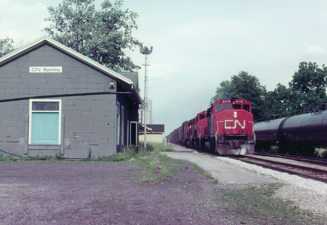 One chance I get to catch a freight while in the village of Wyoming, ON.,and for obvious safety reasons I cannot cross the tracks. So this is what I get. CN 9476, 9589 and 9479, a trio of GP40-2L(W, really blew thru here; was caught off guard by the speed limit. Must have been 55 MPH at least. For what its worth, I did make note the caboose on the end of train was #79438.  I do not recall the next time I managed to get out to the station for another action shot,(maybe 1979) but when I did, the building was gone.