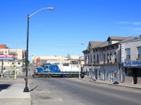 The once a week SOR job that serves to last surviving customer on the Burford spur has just set off the traffic lights at the corner of Colborne and Clarence Street and are rolling past the old downtown in Brantford, on their way to the former TH&B trackage. GP9 4003 has become a regular for this job based out of Hamilton.