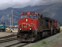 CN2535 Departs after a crew change in Jasper, while VIA crews work on getting VIA 6418 ready shortly after a thunderstorm passes through.