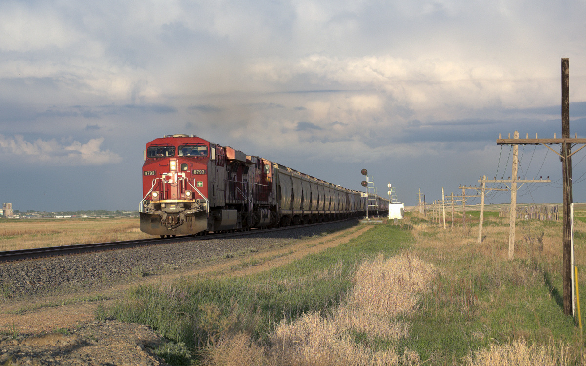 Heading west into Boharm, SK with one of the many elevators in Moose Jaw visible in the background. The sun starts to shine after a prairie thunderstorm.