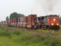 With all the smoke from the fires and a thunderstorm, you wouldn't think its 5 pm in July. CN 2712 departs after waiting for a southbound CP potash train and a westbound CN inter modal.