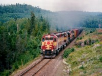 The daily #10 roars out of Hawk Junction on its late afternoon departure for Sault Ste. Marie. Five units on the head end for the climb. WC 6581, 6522, 6006, 6583 and 589. The 6006 is still in AC paint. Last unit 589 is a relatively scarce EMD SDL39, it is still active, but now down in Chile. In this photo it was just mooching a ride.