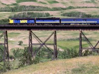 I got on my bicycle and rode to Fabyan. I rode alone and it was the longest that I would ever ride in a day. I hated it. I knew nothing about hydration and nutrition, and I was very annoyed by the loneliness. After work, my wife caught up to me in the car and we camped nearby. The next morning, we decided to check out the large bridge over the Battle River. Traffic was slow, but eventually the "Super Continental" came by. This is not your typical view of the bridge.