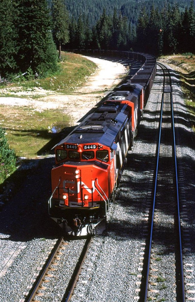 I have been up and down this stretch of road (Kamloops to Jasper) several times, but considering that it parallels the CN the entire way, I have very few photos to show for it. For those that have traveled this route, you know that it is heavily forested, very lightly developed, and more likely than not, you are just trying to make miles - it is a long journey. Don't get me wrong, there are a few places where I would love to linger and catch a few trains. The area from Kamloops to Barriere seems quite intriguing, as is the 60 km west of Jasper. But in between, most is hidden or inaccessible.
Here, we caught a westbound coal train, just south of Blue River as it is about to pass under the highway. Chasing it would be very time consuming as we were headed east. The road crosses the North Thompson River almost immediately, while the tracks remain on the west bank all the way back to Avola (about 30 km).
