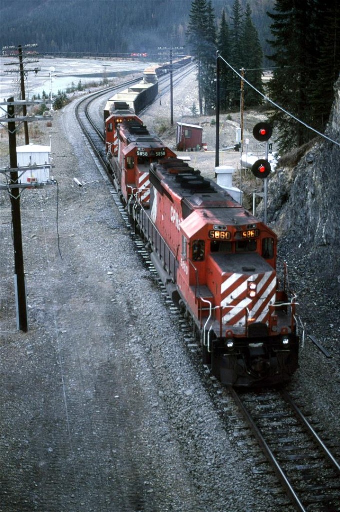 One of the problems with photography in the mountains in the Fall is that the sun takes a while to reach the tracks. It will still be some time before this scene is warmed by direct sunlight.
We were returning to Edmonton from the Alta-Mont railfan event in Essex with my brother from Halifax, and decided to take the long way home by going through Kicking Horse Pass. We caught this Sulphur train leaving Field. We did not linger, though. These trains were rather odoriferous.