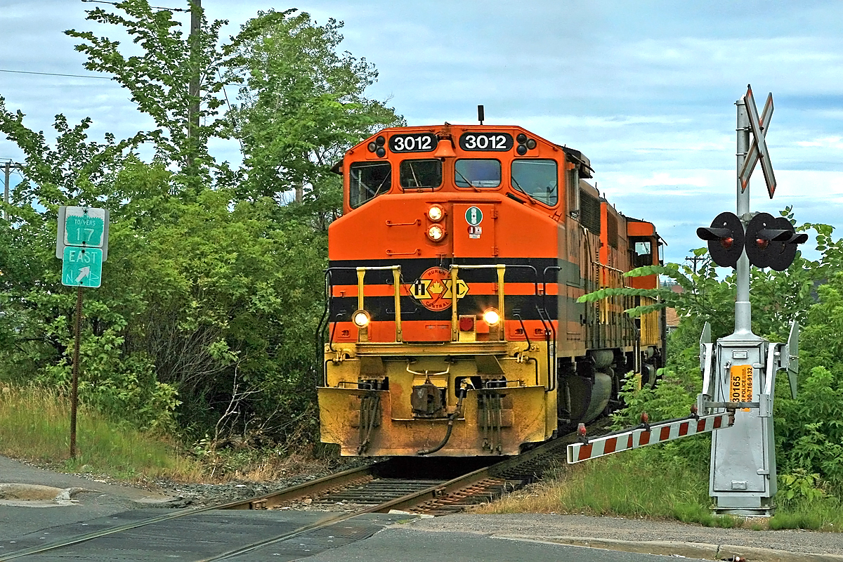 HCRY 3012 leads a very short train out of the yard in Sudbury westbound toward Copper Cliff, about to cross Regent Street at one of Ontario's wonkier road intersections - even by Sudbury standards! Within a 100' radius Regent intersects with Ontario St. and Riverside Dr. on the south of the tracks and Lorne St. on the north.