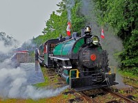 Conductor Dave Lucas has ushered all the passengers back on board the train but still has to walk back to the rear of the train before giving me the flag to go so I take the brief opportunity to vacate my seat and take a few quick shots before we return to Rotary Village Station on the first run of the first day of the 2016 "Steam Season" on the HLBR. The rain and lees than warm temperatures didn't dampen spirits on this Canada Day, just made the steam condense more and hang in the air longer, adding to the ambiance of the image.