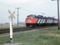 Pool 5 the La Salle is about to cross Lake Road Bowmanville, in this May 1965 photo. A few years earlier Bowmanville was a regular stop for No. 5 but not in 1965. The Pool Agreement will soon end too. The well maintained track and clean right of way are typical of CN in the 1960s. I'm not sure if this was still the Oshawa Sub. or had been changed to Kingston Sub. by 1965.