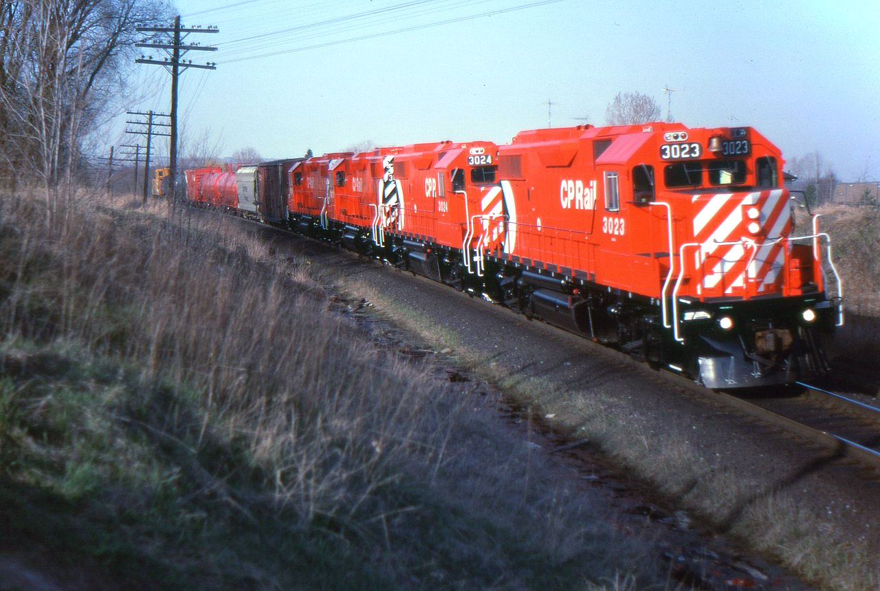 Fresh out of GMD London, CP's first four GP38-2s are on the Cobourg turn westbound at Bowmanville. 3023 is leading 3024, 3022 and 3021. Over one hundred more GP38-2s will follow in the next three years. 3000-3020 were slightly different model GP38-ACs.
