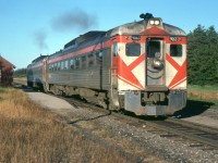 Havelock to Toronto Sunday only train 383 is seen passing Burketon Ontario 40 years ago, on July 25, 1976. This was a popular way to travel from Peterboro to Toronto and a great convenience to people in Havelock and other small communities on the line. VIA maintained it until the infamous cuts of January 1990. Proposals to restore the service failed and are more unlikely now with the completion of highway 407 coming soon. In the photo, the station has been replaced with a shelter and the train is accelerating as there are no passengers at the flag stop.