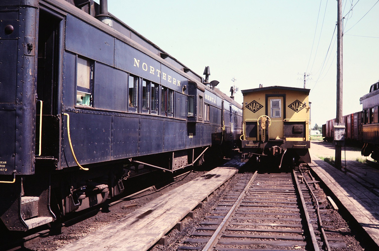 Comboose 303 sits beside bay window caboose 13003. Photo taken by my brother during a shop tour.