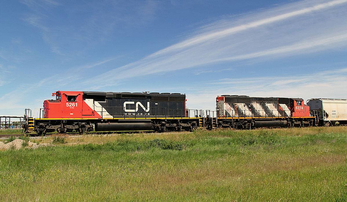 A pair of SD40-2(W)'s head down the Fort Saskatchewan industrial lead with a cut of hoppers and tank cars.