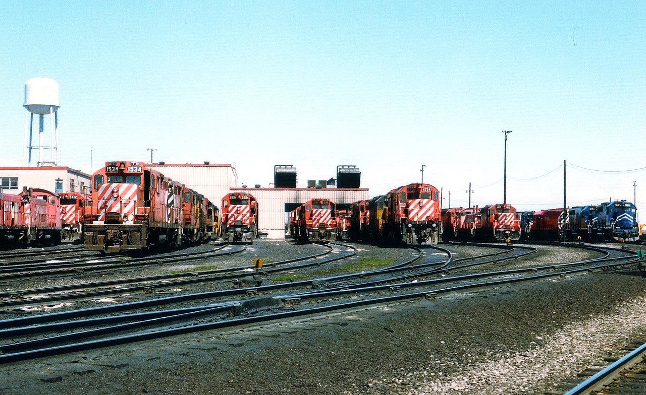 A visit on a "good" day to the CP yard in Agincourt 30 years ago would present us with enough power to drool (or should that be "foam") over. In this photo there must be upwards of 40 locomotives basking in the sunshine. In the days of film we could go broke just shooting slides/prints of them all. That is, if we were allowed to wander at will. But no, all photos had to be taken from along the roadway. Even that was great while it lasted. This view shows various switchers, GPs, MLWs, a smattering of Chessie as well as a few former Missouri Pacifics now lettered for GATX, which were on lease to CP around that time. Nowadays, don't even bother trying to go there...........