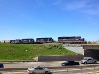 A CEMR train with 4 locomotives passing over Pembina Highway in Winnipeg, MB. The power is: CEMR 5396 (SD40-2), CCGX 5308 (SD40-2), CCGX 5309 (SD40-3), CEMR 4000 (GP9RM)