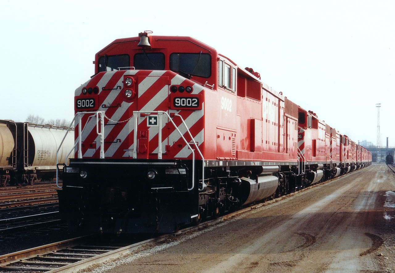 Red Barn-The Wall. So it looks, anyway. A dozen brand new SD40-2F locomotives sit at the CP Quebec St yard on a rather drab Monday afternoon. This is 12 of the 25 units built. Hard to believe they are being retired already, and sightings of what is left have been far and few between. Actually, I am not sure if any of them are out on the road anymore. In this photo we see CP 9002, 9006, 9014, 9023, 9018, 9007, 9012, 9003, 9009, 9000, 9005 and 9004. I had no problem wandering that day, but trespassing on CP property is now prohibited.