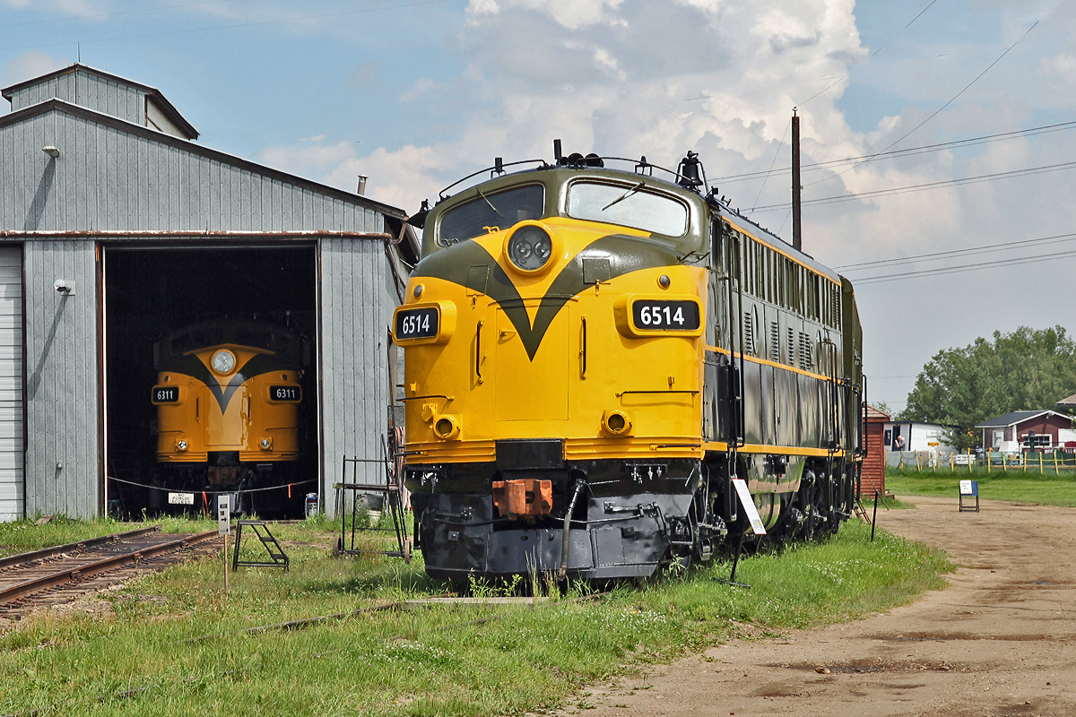 FP9A, CN 6514 was built in 1957.  It was transfered to VIA in 1978, then to the Algoma Central route in 1995.  It was finally retired in 2001 and then in 2003 donated by CN to the museum.  It was seen at the museum for many years in black livery and carrying a "Pioneer Railway" logo (photo 9289), now restored to former CN colours.  I do not know if the locomotive is operational or if this is just a cosmetic restoration, either way she looks splendid.  In the shop behind can be seen CN6311, a privately owned unit, also repainted to original CN colours.