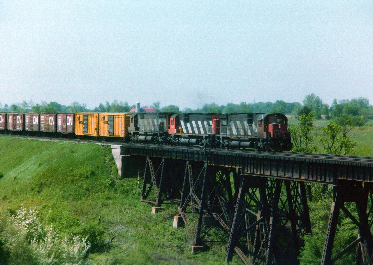 Okay, so I suppose with most of you this is considered Brantford. But it is outside the city proper, so I label it Lynden West. Sounds more "country-ish".  Anyway, back in 1984 at the first of June it was a beautiful morning watching trains over Fairchild Creek. This location I enjoy early; at this time of the year, from sun-up until maybe noon and then the sun angle becomes a negative factor. In this old shot we see grimy old (the way we remember them) MLW C-630M 2024 and 2039 and M-636 2329 trailing, running eastbound.  Fan favourites back then, and even in 1984 not all that common any more. They were off the roster by 1996.