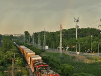 Quebec City to Toronto manifest M 30921 17 rolls through the West Island catching the last rays of sunlight, as a rainbow lights up the dull sky.  Breaking the trend of AC GEVos on everything, 309 provides a brief reprieve with a trio of DC GEVos (Sad how this is considered interesting...) CN 2327, CN 2288 and mid train DP CN 2310 keep this 142 car drag moving westwards.