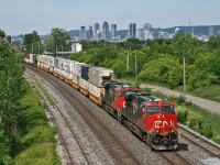 With the City of Montreal's skyline in the distance, hot shot Q 12031 18 pulls their 205 car train off the Victoria Bridge, enroute to Joffre and eventually Halifax, Nova Scotia.  Power today was CN 2840, CN 2870 and mid-train DP CN 2817, with over 13,000ft of traffic for the east coast.

