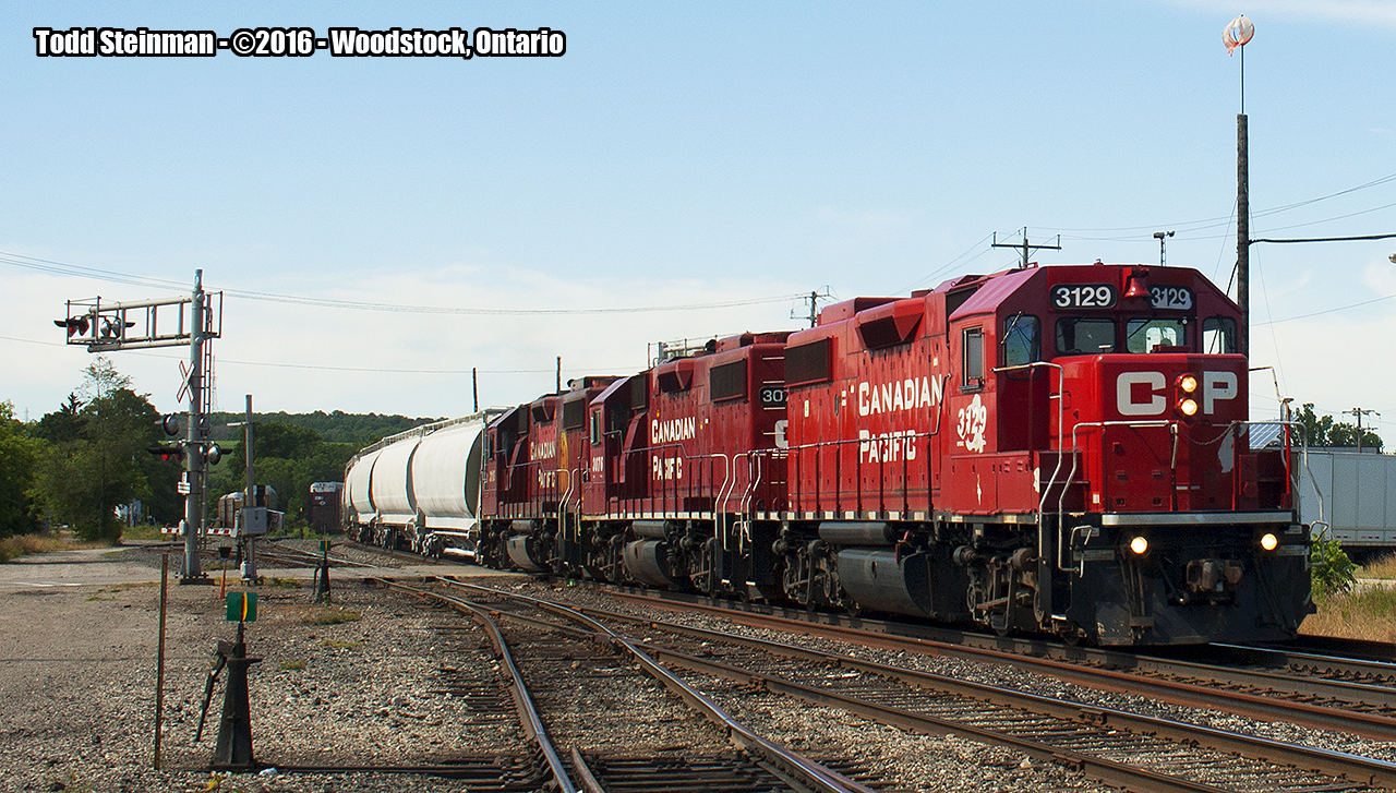 CP 3129 leads the local eastbound across Ingersoll Avenue in Woodstock.