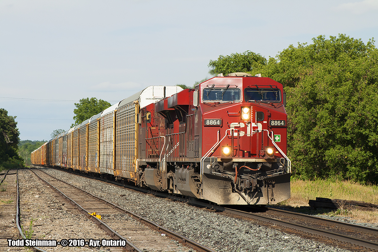 A westbound autorack train, with two CP units in charge (8864 & unidentified) roll through Ayr.