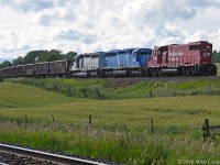 Nearing the end of it's run dumping ballast between Lovekin and Port Hope, CP 4426, CEFX 3143, and CEFX 3109 round the curve a few hundred feet from the west home signal at Port Hope. Problems with the 3143 necessitated the addition of 4426 at Toronto Yard, which wasn't all bad given the not so common long hood forward orientation of the remote control equipped geep leading on the main. The return trip also saw the 4426 leading back to Toronto, the crew having run around the SD's in the back track at Spicer, where they ended their eastbound movement. 1747hrs.