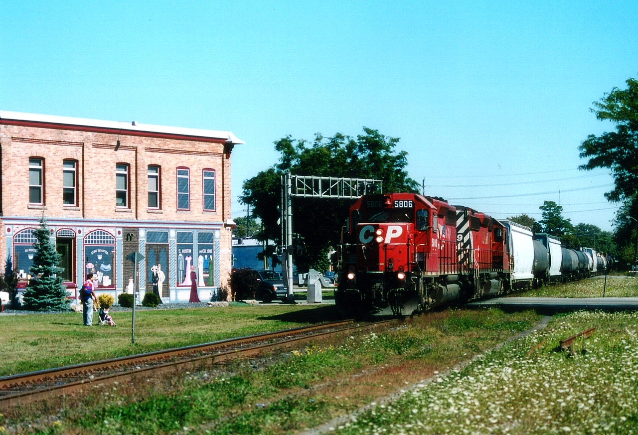 Westbound CP 5806, 6019 crosses William St S in downtown Chatham. The public land around here at the time made it a nice place to park and listen for freight moves.  And I liked the building.  If you did not notice right away that all those storefronts are fake, as are two upstairs windows, then the artists have accomplished what they set out to do.
