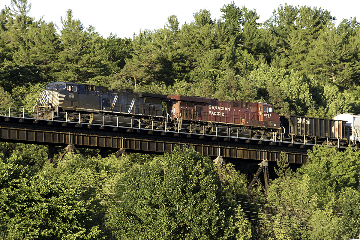 As the days light is almost gone, CEFX 1055 west leaps out of the trees onto the famous trestle over the Seguin River.